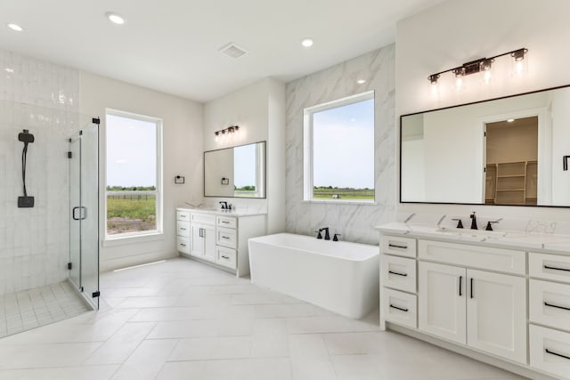 1324 Streetman Rd, Royse City, TX 75189 - full bathroom featuring a stall shower, a freestanding bath, two vanities, recessed lighting, and tile patterned floors