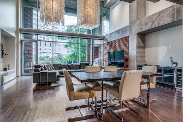 2011 Cedar Springs Rd Unit 106, Dallas, TX 75201 - dining space featuring a towering ceiling, a wall of windows, and wood finished floors