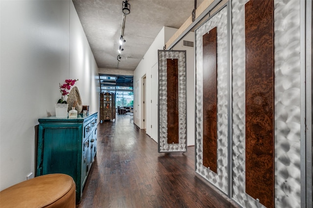 2011 Cedar Springs Rd Unit 106, Dallas, TX 75201 - hallway featuring dark wood finished floors and rail lighting