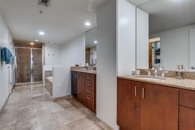 2011 Cedar Springs Rd Unit 106, Dallas, TX 75201 - bathroom with a shower stall, two vanities, a bath, and recessed lighting