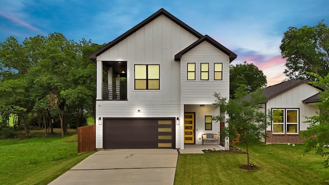 404 Bobbie St, Dallas, TX 75203 - view of front of property featuring board and batten siding, concrete driveway, a lawn, and an attached garage