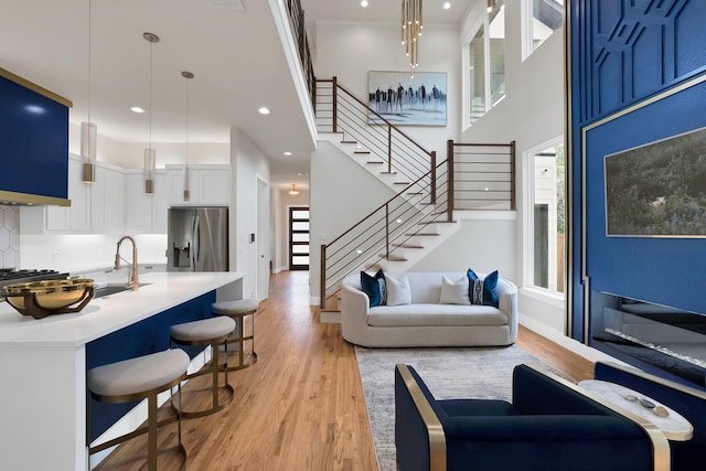 404 Bobbie St, Dallas, TX 75203 - living area with stairway, light wood-type flooring, recessed lighting, a high ceiling, and baseboards