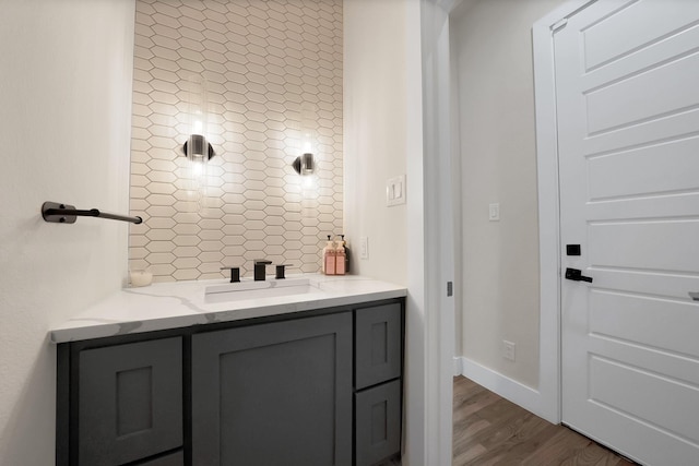 404 Bobbie St, Dallas, TX 75203 - bathroom with wood finished floors, vanity, and baseboards