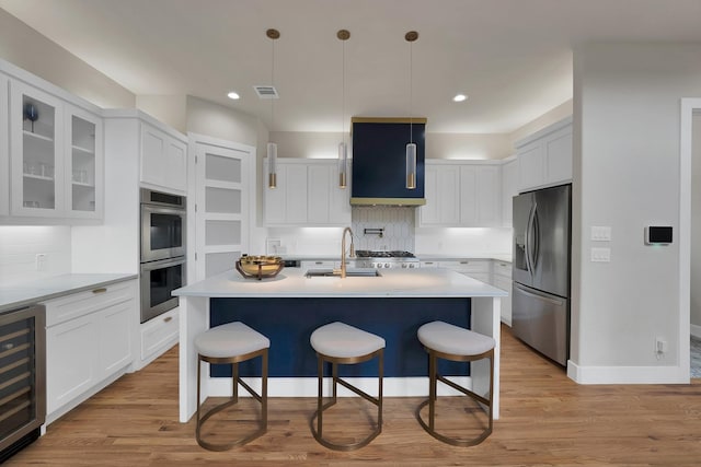 404 Bobbie St, Dallas, TX 75203 - kitchen with appliances with stainless steel finishes, a sink, beverage cooler, a kitchen bar, and recessed lighting