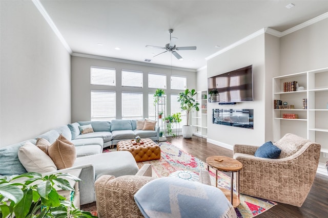 4220 Colton Dr, Carrollton, TX 75010 - living room featuring crown molding, ceiling fan, wood finished floors, baseboards, and a glass covered fireplace