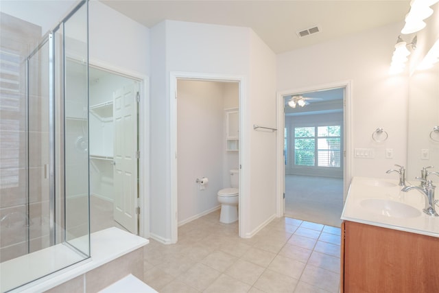 4001 Stone Oak Blvd, Denton, TX 76210 - bathroom with ceiling fan, a shower stall, toilet, tile patterned floors, and double vanity