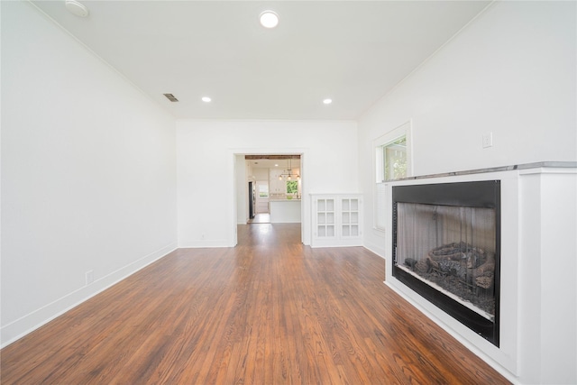 107 W Myrtle, Winnsboro, TX 75494 - unfurnished living room with wood finished floors, a fireplace, baseboards, crown molding, and recessed lighting