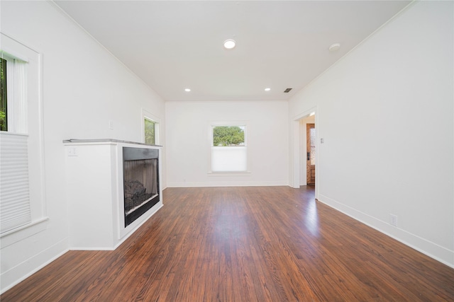 107 W Myrtle, Winnsboro, TX 75494 - unfurnished living room featuring a fireplace, dark wood finished floors, baseboards, crown molding, and recessed lighting