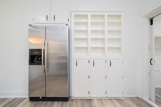 107 W Myrtle, Winnsboro, TX 75494 - kitchen with stainless steel refrigerator with ice dispenser, light wood finished floors, and white cabinets
