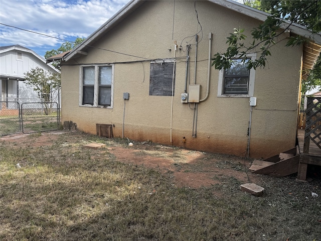 2958 Russell Ave, Abilene, TX 79605 - view of side of home featuring stucco siding and a gate
