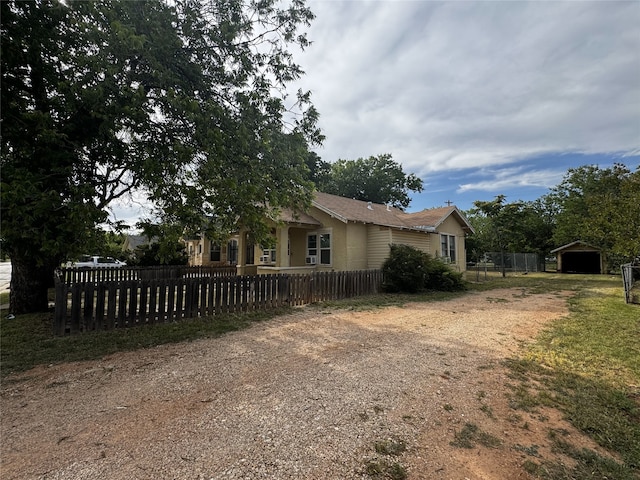2958 Russell Ave, Abilene, TX 79605 - view of side of home featuring driveway, a carport, and an outbuilding