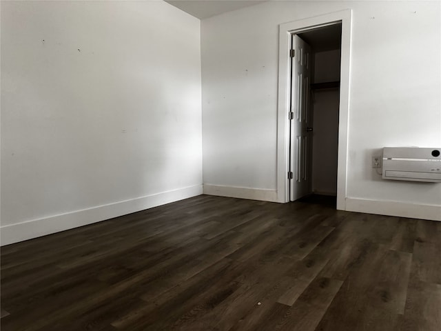 2958 Russell Ave, Abilene, TX 79605 - empty room featuring dark wood-style floors, baseboards, and a wall mounted AC