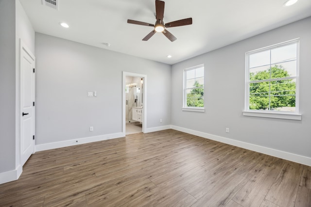 4002 Robert L Parish Sr Ave, Dallas, TX 75210 - unfurnished bedroom featuring wood finished floors, baseboards, ensuite bath, recessed lighting, and a ceiling fan