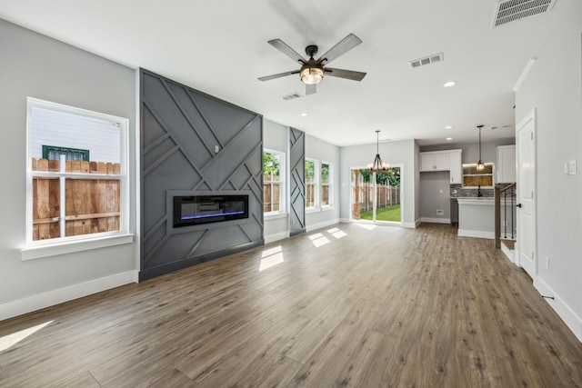 4002 Robert L Parish Sr Ave, Dallas, TX 75210 - unfurnished living room with a fireplace, wood finished floors, ceiling fan, baseboards, and recessed lighting