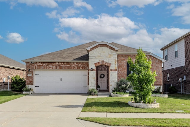 3125 Layla Creek Dr, Little Elm, TX 75068 - view of front facade featuring an attached garage, concrete driveway, a front lawn, and stone siding