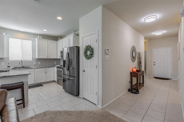 3125 Layla Creek Dr, Little Elm, TX 75068 - kitchen featuring stainless steel appliances, light tile patterned floors, tasteful backsplash, a sink, and recessed lighting