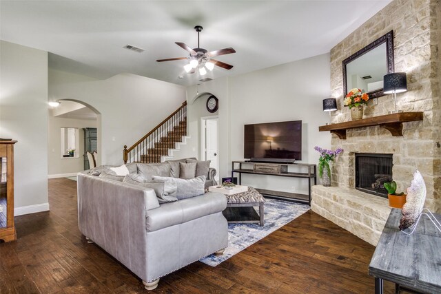 921 Yarwood Way, Burleson, TX 76028 - living area featuring ceiling fan, arched walkways, hardwood / wood-style floors, a stone fireplace, and baseboards