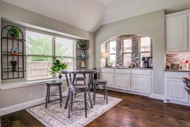 921 Yarwood Way, Burleson, TX 76028 - dining room with plenty of natural light, lofted ceiling, dark wood-style flooring, and baseboards