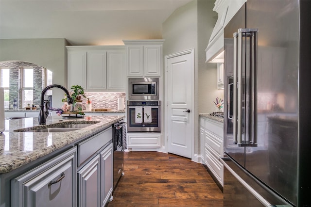 921 Yarwood Way, Burleson, TX 76028 - kitchen featuring appliances with stainless steel finishes, a sink, white cabinetry, tasteful backsplash, and dark wood finished floors