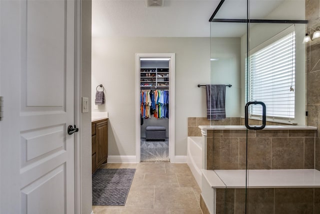 921 Yarwood Way, Burleson, TX 76028 - full bathroom with a bath, vanity, a shower stall, a spacious closet, and baseboards