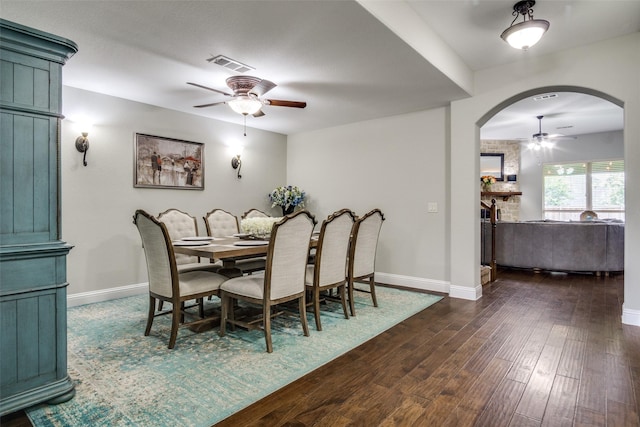 921 Yarwood Way, Burleson, TX 76028 - dining room featuring ceiling fan, arched walkways, dark wood-type flooring, and baseboards