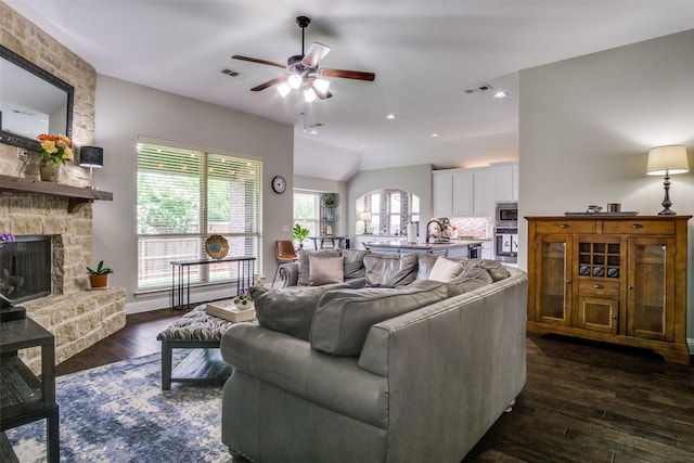 921 Yarwood Way, Burleson, TX 76028 - living area with ceiling fan, a stone fireplace, dark wood-type flooring, and baseboards