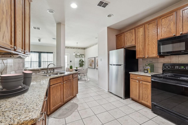 6826 Dream Dust Dr, North Richland Hills, TX 76180 - kitchen with black appliances, a sink, backsplash, brown cabinets, and light tile patterned flooring