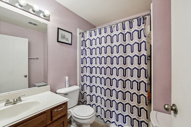 6826 Dream Dust Dr, North Richland Hills, TX 76180 - full bathroom featuring toilet, a textured wall, vanity, and a shower with shower curtain