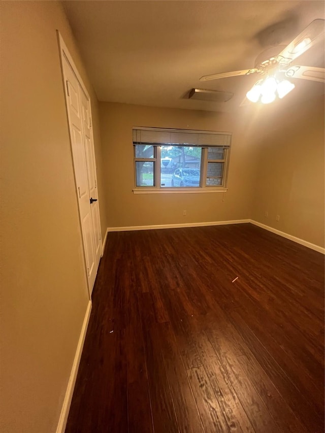 332 Belmont St, Hurst, TX 76053 - unfurnished bedroom with dark wood-type flooring, baseboards, and ceiling fan