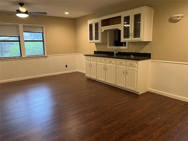 332 Belmont St, Hurst, TX 76053 - kitchen featuring a wainscoted wall, dark wood-style flooring, a sink, a ceiling fan, and dark countertops