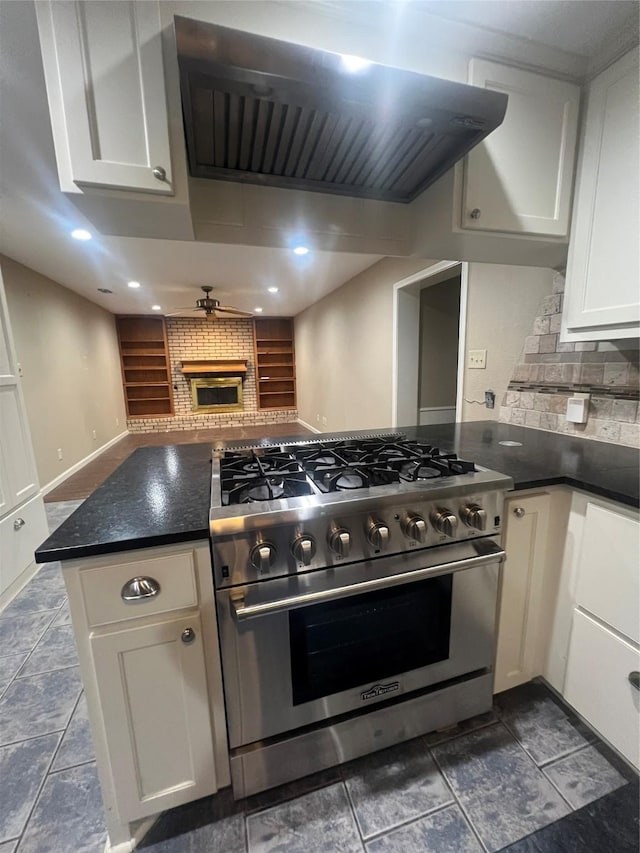 332 Belmont St, Hurst, TX 76053 - kitchen featuring high end range, ventilation hood, tasteful backsplash, white cabinets, and recessed lighting