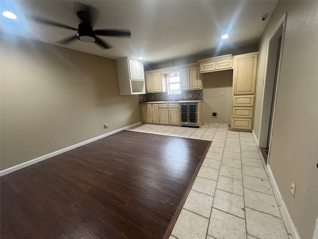 332 Belmont St, Hurst, TX 76053 - kitchen with beverage cooler, light wood-type flooring, a sink, baseboards, and a ceiling fan