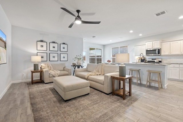 140 Orchard Pines Pl, Boyd, TX 76023 - living room with light wood-style floors, ceiling fan, baseboards, and recessed lighting