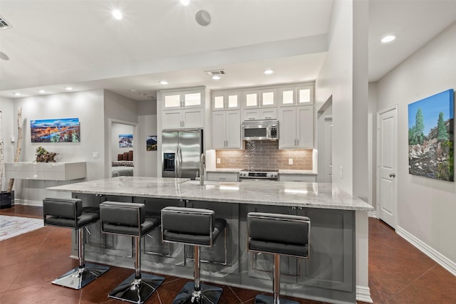 124 Robin Hood Way, Gun Barrel City, TX 75156 - kitchen featuring stainless steel appliances, white cabinetry, recessed lighting, a spacious island, and a sink