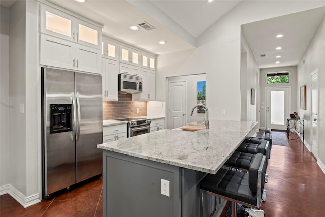 124 Robin Hood Way, Gun Barrel City, TX 75156 - kitchen with stainless steel appliances, a sink, tasteful backsplash, white cabinets, and light stone countertops