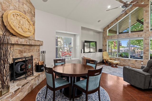 124 Robin Hood Way, Gun Barrel City, TX 75156 - dining space with a ceiling fan, healthy amount of natural light, high vaulted ceiling, dark tile patterned floors, and a stone fireplace