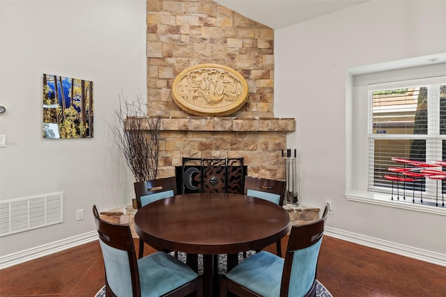 124 Robin Hood Way, Gun Barrel City, TX 75156 - dining space with baseboards, a fireplace, lofted ceiling, and tile patterned floors