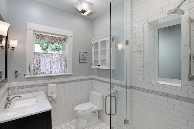 211 N Waddill St, Mckinney, TX 75069 - bathroom featuring tile walls, vanity, a stall shower, toilet, and wainscoting