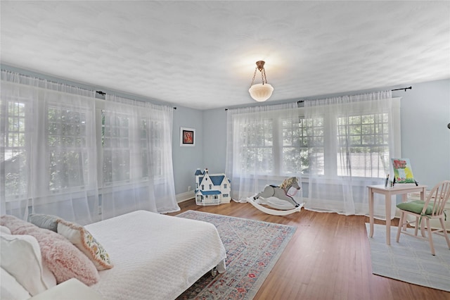 211 N Waddill St, Mckinney, TX 75069 - bedroom with baseboards and wood finished floors