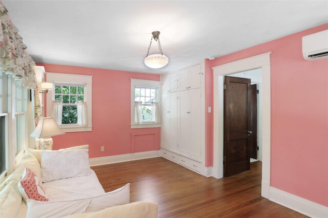 211 N Waddill St, Mckinney, TX 75069 - living area featuring a wall mounted air conditioner, wood finished floors, baseboards, and healthy amount of natural light