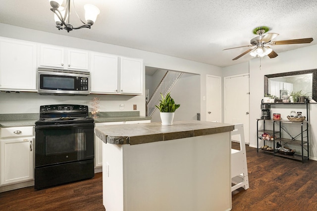 10216 Scurry Ct, Fort Worth, TX 76108 - kitchen with stainless steel microwave, black electric range oven, dark wood finished floors, a center island, and white cabinets