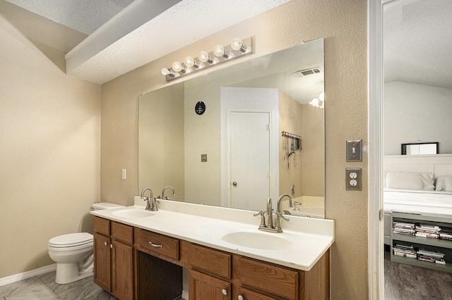 10216 Scurry Ct, Fort Worth, TX 76108 - full bathroom featuring toilet, connected bathroom, double vanity, a textured ceiling, and baseboards