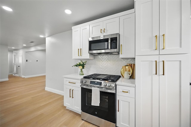 3651 Cindy Dr, Fort Worth, TX 76111 - kitchen featuring appliances with stainless steel finishes, baseboards, tasteful backsplash, light wood-style floors, and light countertops