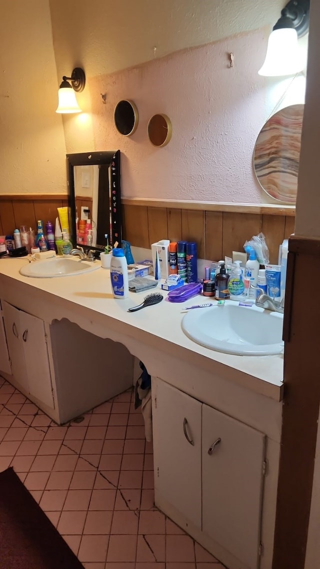 5612 Wainwright Dr, Fort Worth, TX 76112 - bathroom with vanity, wainscoting, a textured wall, and tile patterned flooring
