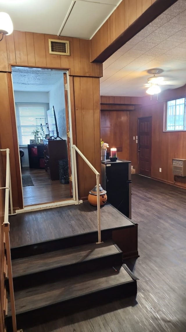 5612 Wainwright Dr, Fort Worth, TX 76112 - stairway with ceiling fan, wooden walls, wood finished floors, and heating unit