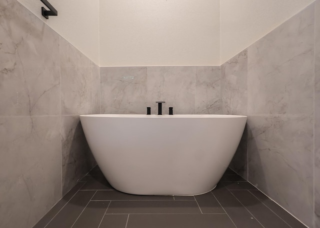 2836 Ave L, Fort Worth, TX 76105 - full bath featuring a freestanding bath, tile walls, and tile patterned flooring