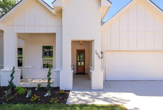 2836 Ave L, Fort Worth, TX 76105 - view of front of home featuring an attached garage, board and batten siding, and brick siding