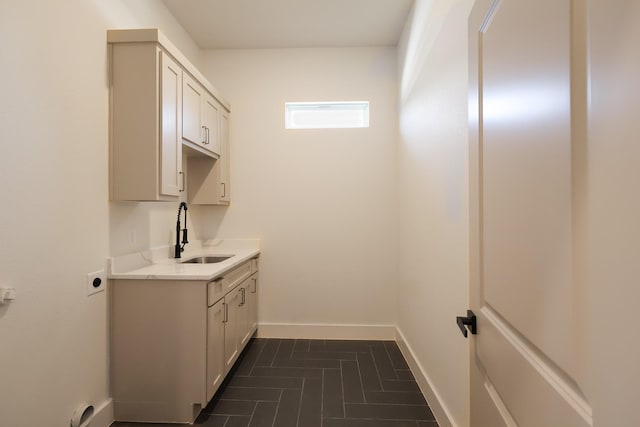 2836 Ave L, Fort Worth, TX 76105 - laundry area featuring cabinet space, hookup for an electric dryer, and baseboards