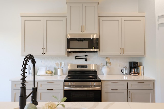2836 Ave L, Fort Worth, TX 76105 - kitchen with stainless steel appliances, backsplash, and light stone countertops