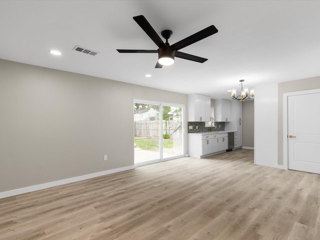 1013 Nueva Tierra St, Grand Prairie, TX 75052 - unfurnished living room featuring a chandelier, baseboards, recessed lighting, light wood finished floors, and ceiling fan